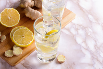 A glass of ginger water on marble table. Detox drink.