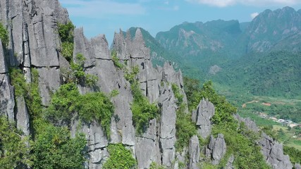Aerial view of village Vang Vieng and Nam Song rive , Laos. Southeast Asia. Photo made by drone from above. Bird eye view..
