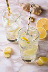 A glass of ginger water on marble table. Detox drink.