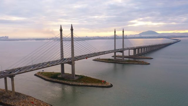 Aerial dramatic sunrise view with traffic at first Penang Bridge, Malaysia. 
