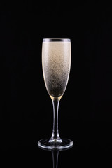 glass with white wine champagne on a black background