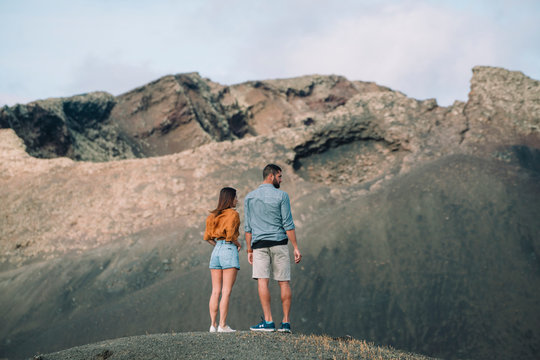 Couple standing at Volcano Cuervo in Lanzarote, Spain