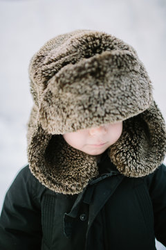 Closeup of Toddler Boy in Furry Trapper Hat in the Snow