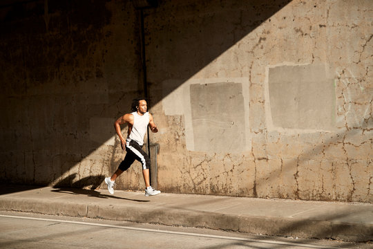 African-American man running on sidewalk