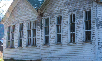 Old abandoned building with faded white siding