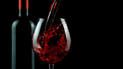 Detail of pouring red wine into glass
