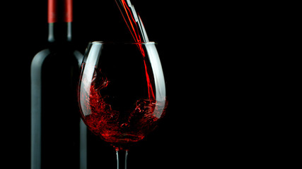 Detail of pouring red wine into glass