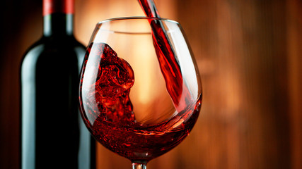 Detail of pouring red wine into glass