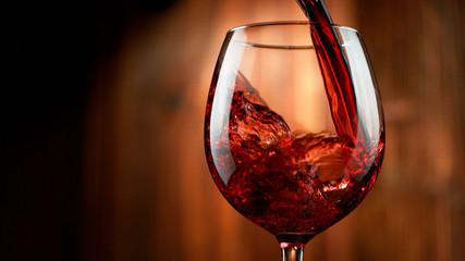 Detail of pouring red wine into glass