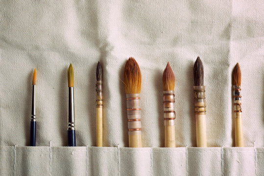 Paintbrushes on a cloth.