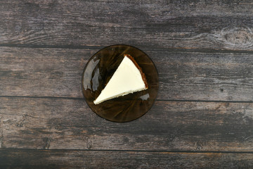 Cheesecake on a dark wooden background. view from above.