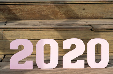 Creative inspiration concepts 2020 with golden text number with wooden background. Business resolution, ideas for action plans.