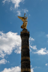 Berlin victory column in front of a blue sky with some clouds