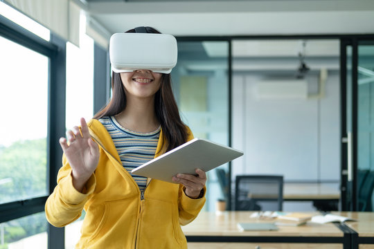Young programmer with virtual reality glasses to testing 3D appl