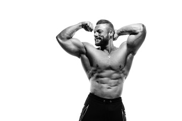 Black-white portrait of a smiling athletic man with a naked torso demonstrates biceps isolated on a white background.