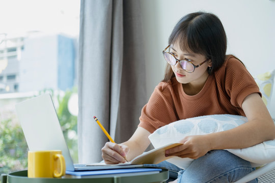 Collage student female reading and researching form book.