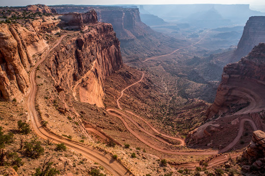 A jeep road winds down the side of a canyon in Canyonlands Natl Park.