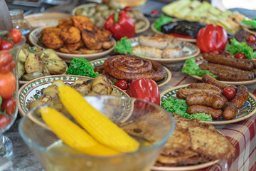 Festive table with grilled meat products and potato, decorated with red pepper and rabbit look tasty and tempting. Slashing dinner.