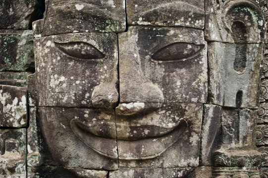 Carved face at Angkor Wat, major historical landmark of Cambodia