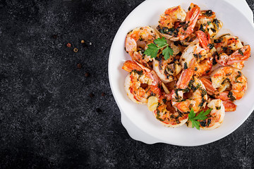 Grilled shrimps. King prawn tails in orange-garlic sauce with parsley. Top view, copy space