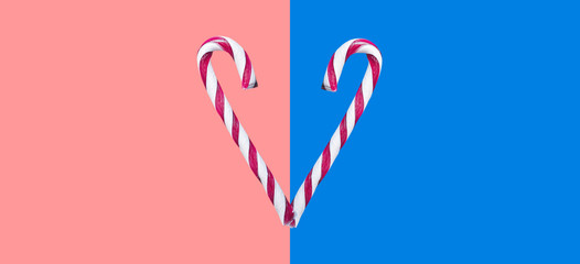 Heart Shaped Christmas Candy On Pink And Blue Background