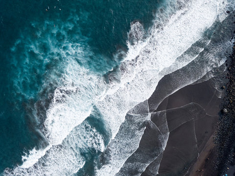 Aerial view of beach and shorelin, waves and surfers