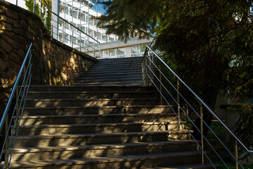 stone staircase, iron railing, Sunny day, shadows from trees