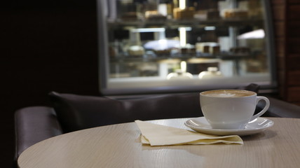 cup of coffee on the table with napkin