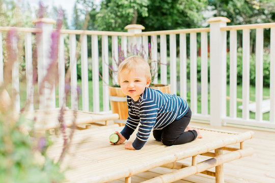 Baby boy crawling on balcony