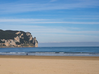 Beach landscape with horizon line and blue sky in Laredo, Spain