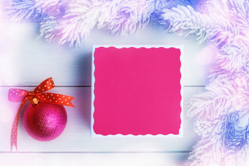 Gift box with blank greeting card mock-up over light Christmas background