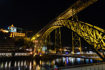 Fototapeta na wymiar Night view of the Dom Luis I bridge from the ribeira dock