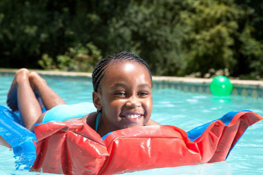 Girl lying on a pool floater