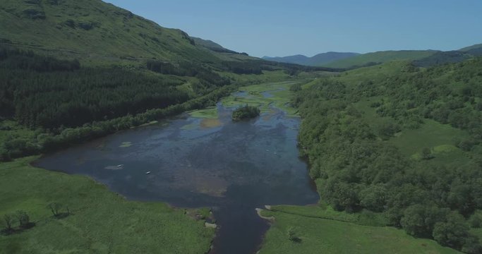 High aerial approaching Loch Dochart in lush green glens, classic Highland setting