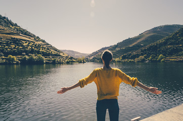 Woman gazing happily at the Douro Valley in Portugal