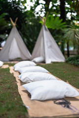 Small tipi indian tent with pillows in the woods