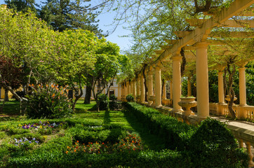 Fototapeta na wymiar Portuguese garden with flowers and Greek style columns