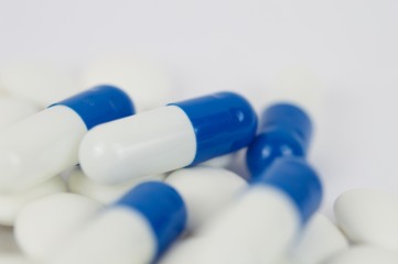 Blue capsules and white pills