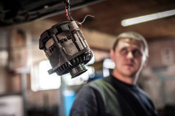 Car mechanic working in auto vulcanizing and vehicle service workshop