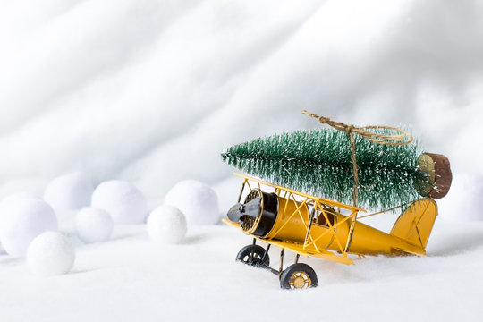 Christmas Tree On Vintage Airplane Toy. Happy Holidays Concept. Copy Space