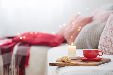 cup of tea with burning candles at home