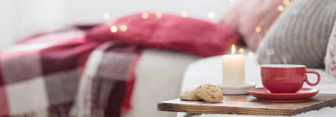 cup of tea with burning candles at home