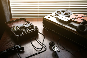 Reel tape recorder for wiretapping. Field telephone set USSR is lying nearby.  KGB spying conversations.