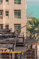Construction worker working on a building site near sea