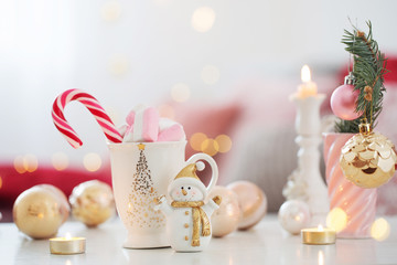 cocoa with marshmallow  and christmas decor in pink and gold colors