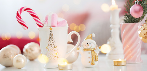 cocoa with marshmallow  and christmas decor in pink and gold colors