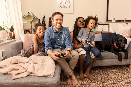 Family playing video game - Powered by Adobe