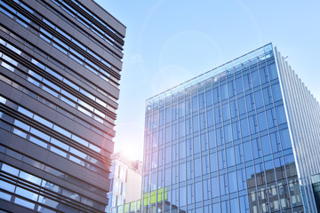 Modern office building detail, glass surface with sunlight. Business background. 