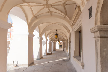 Old renaissance or mannerist arcades of tenement house in Zamosc Poland, example of Lublin renaissance, renesans lubelski, ceiling covered with stucco mannerist ornaments