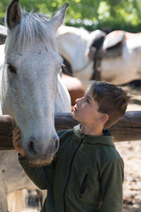 Niño con su mejor amigo, su caballo blanco. 